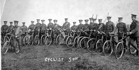 Soldiers get on their bikes to join their units.